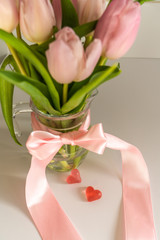 Bouquet of pink tulips with hearts on a white background