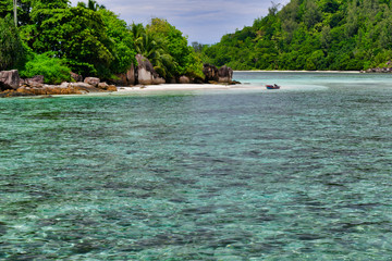 Tropical island with boat, Therese Island, Mahe, Seychelles. Horizontal view.