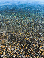 Transparent sea water with pebbles
