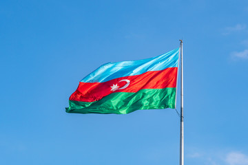 Azerbaijan Flag against blue sky in Baku.