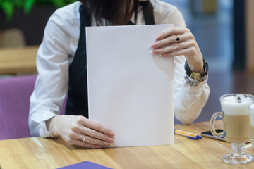 the girl holds the white magazine in hand