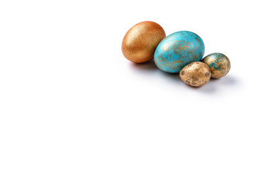 Blue and golden modern easter eggs on a white background. Copy space. Isolated.
