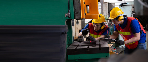 Asian factory engineer wearing yellow hard hat and checking the machine, Annual maintenance concept