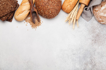 Various bread with wheat, flour and cooking utensils