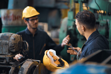 Scene shot of 2 industrial workers arguing planning, the procedure of work in the factory with selective focus, concept industrial workers process, manufacturing operation, working confliction. - obrazy, fototapety, plakaty