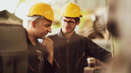 Scene shot of 2 industrial workers discussing about planning, the procedure of work in the factory...