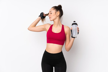 Young sport brunette woman over isolated white background with sports water bottle
