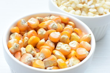 grains of natural corn in containers