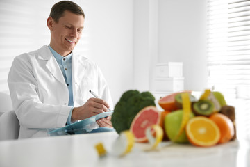 Nutritionist working at desk in his office