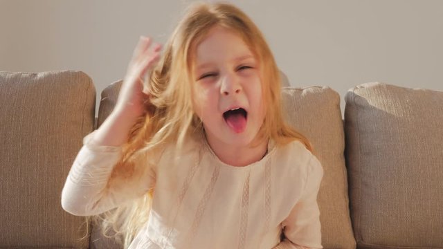 Cheeky little girl. Cute little girl grimacing