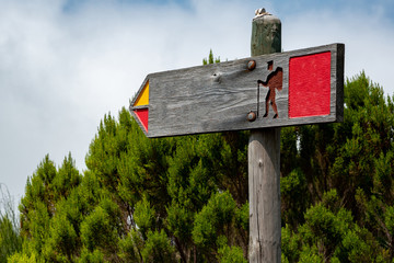 A sign indicating the direction of the Hiking route. There is a free space on the sign for the inscription.