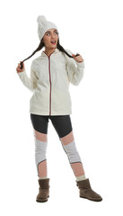 Woman wearing stylish winter sport clothes on white background