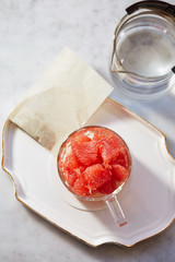 Pink grapefruit in glass cup 