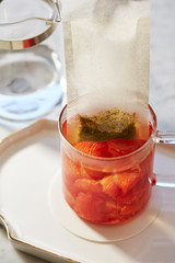 Pink grapefruit tea in glass cup 