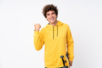 Handsome young skater man over isolated white wall