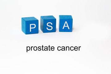 the letters PSA on blue blocks against isolated white background stand for.Prostate specific antigen. The words prostate cancer are mentioned in the photo