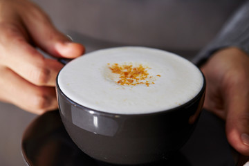 Cafe latte in black coffee cup