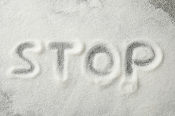 Inscription Stop made of sugar on grey background, top view