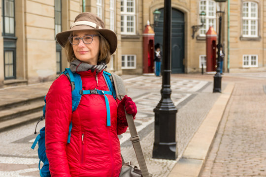 Mature woman tourist  in front of Amalienborg Palace in Copenhagen Denmark
