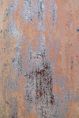 Old painted and rusted metal sheet with scratches as background. Texture of a rusty steel panel.