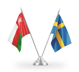 Sweden and Oman table flags isolated on white 3D rendering