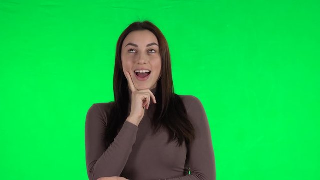 Attractive girl waiting in anticipation with pleasure. Green screen