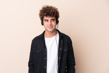 Telemarketer man working with a headset over isolated background standing and looking to the side