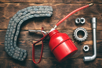 Red oil can and car spare parts. Lubrication.