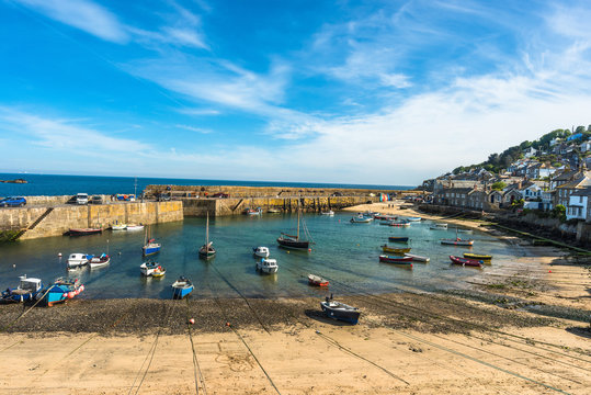 Small fishing boats in Mousehole harbour Cornwall England GB UK EU Europe