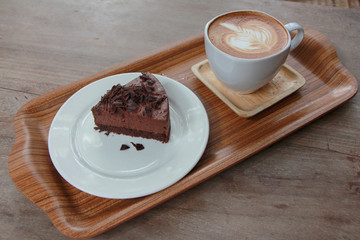 Chocolate cake with latte art coffee. 