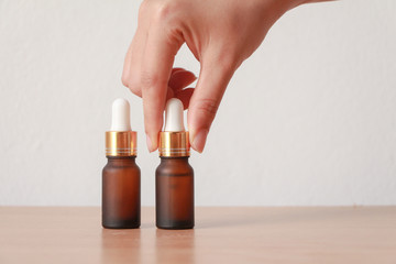 facial essential oil or serum packaging on wood table against White Background. Beauty cosmetic product for skincare concept.copt space.