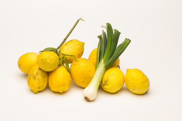Yellow lemons and fresh green vegetables