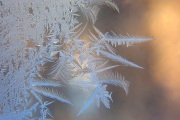 frosty patterns on the window glass closeup. natural textures and backgrounds. ice patterns on frozen