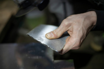Metal cutting. Grinding steel. Work as a grinder. Sparks from friction. Men's work. Creating a...