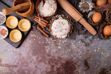 baking ingredients for a cake top view on dark rough background