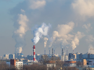 A lot of smoke from tubes above the city