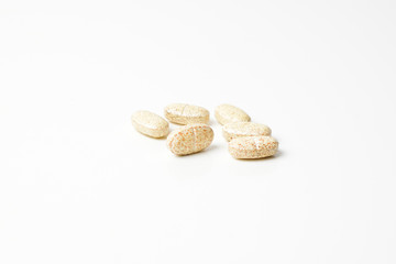Multivitamin pills on a white background.