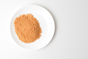 Powdered dried vegetables and meat.  Tomato protein soup on a plate. Meal replacement.
