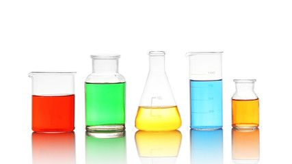 Different laboratory glassware with colorful liquids isolated on white