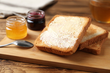 Delicious crispy toasts and jams on wooden table