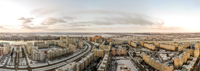 large winter panorama cityscape aerial drone view - wide snowy Chekist Avenue and the 70th anniversary of October Street (Krasnodar, Russia) surrounded by high-rise apartment buildings surrounded by 