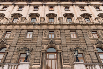 European palace architecture exterior facade building stone wall and window outside urban landmark view foreshortening from below