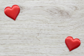 Wooden background with two hearts