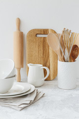 Kitchen white tableware wooden utensils on the table.
