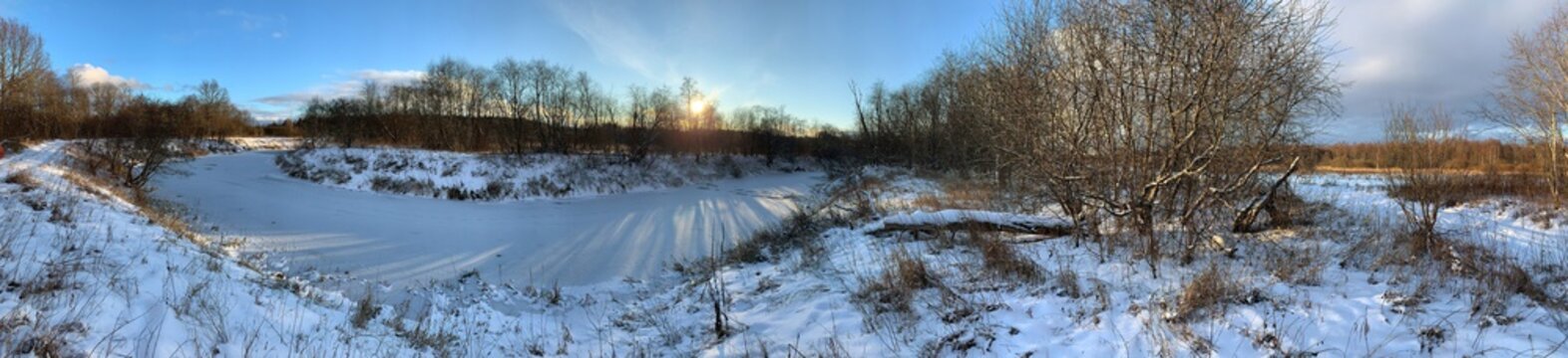 Panoramic view with winter river and snow forest. Beautiful winter landscape