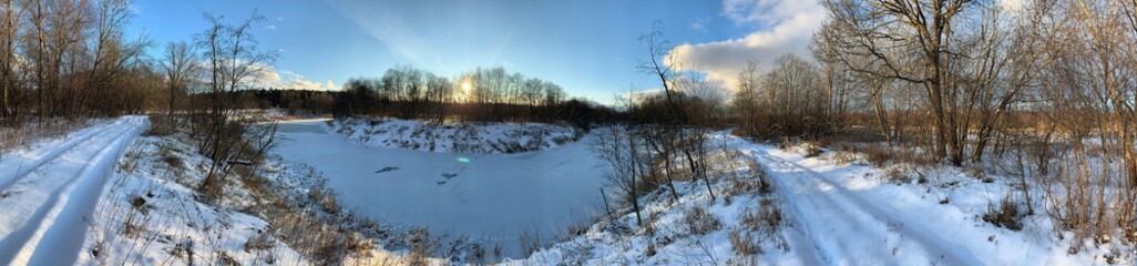Naklejka na ściany i meble Panoramic view with winter river and snow forest. Beautiful winter landscape