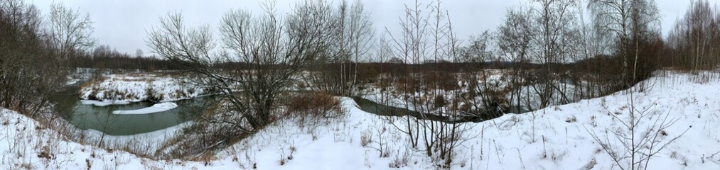 Panoramic view with winter river and snow forest. Beautiful winter landscape