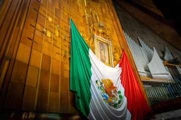 Our Lady of Guadalupe with mexican flag in Mexico City
