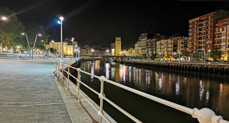Panoramic view of Bilbao at night with the estuary