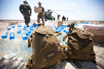 Delivery of humanitarian aid by military helicopter - obrazy, fototapety, plakaty